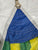 Colorful sail with blue, green, and yellow sections on a white background